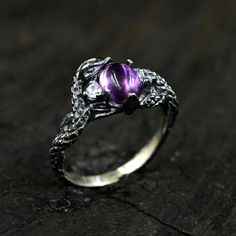 Embrace the allure of ancient legends with our Amethyst Snake Ring. Meticulously handcrafted to mimic the intricate scales of a mystical serpent, this ring is a treasure for any fantasy jewelry lover. The rich purple amethyst is nestled within the serpent's coils, symbolizing wisdom and royalty. Perfect for those who are drawn to medieval aesthetics or have a penchant for gothic glamour. Make a bold statement with this unique, textured silver ring that whispers tales of enchanted realms and serpentine magic. Care Instructions: To keep your jewelry looking its best, avoid contact with chemicals, cosmetics, and mechanical damage. Store your jewelry in special cases to prevent scratches and maintain its shine. Additional Features: Custom Orders: We also provide a custom order service. If you Spiritual Nickel-free Jewelry With Round Stone, Silver Metal Jewelry For Promise, Nickel-free Sterling Silver Promise Ring, Mystical White Gold Jewelry Gift, Adjustable Mystical Sterling Silver Rings, Nickel-free Sterling Silver Spiritual Crystal Ring, Nickel-free Spiritual Sterling Silver Crystal Ring, Fine Jewelry Nickel-free Ring, Nickel-free Fine Jewelry Ring