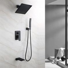 a black shower head and hand shower in a bathroom