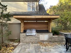 an outdoor bbq with grill and seating area