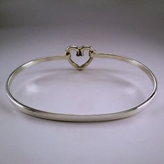 "This sterling silver Open Heart Bangle bracelet features a graceful heart design. The bangle accommodates medium and large spacer beads, European charm-beads, and traditional charms. Made by Brown County Silver. Marked Sterling. Available in small, medium, and large Small - 6.5\" Medium - 7.25\" Large - 8\" Approximate weight is 9.1 grams *Charm not included See more @ https://www.etsy.com/shop/brocosi" Silver Heart Charm Bangle Bracelet, Adjustable Sterling Silver Heart Bangle Bracelet, Sterling Silver Heart Bangle For Wedding, Adjustable Sterling Silver Open Heart Bracelet, Silver Open Heart Bracelet For Wedding, Sterling Silver Heart Bangle For Valentine's Day, Sterling Silver Open Heart Wedding Bracelets, Valentine's Day Sterling Silver Heart Bangle, Sterling Silver Heart Bangle For Anniversary