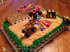 a birthday cake made to look like a monster truck on top of a dirt field