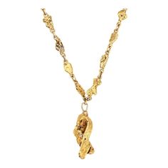 Finely detailed antique Victorian gold nugget necklace (circa 1880s to 1900s), crafted with a 14 karat yellow gold chain and 22k to 24k natural gold nuggets.    The bold and distinct Victorian era necklace highlights a beautiful display of 28 natural gold nuggets. One larger chunkier nugget (1 x 1/2 inch) is set to the 1 1/4 inch drop. Each nugget is created by nature herself, unique, and shines in a bright buttery yellow gold. The collectible necklace is also very wearable and makes a beautiful and unique statement when worn as a standalone piece or layered with your fine jewelry from any era.    The necklace is in very good condition and was lightly cleaned and polished.    Particulars:    Weight: 39.6 grams    Stones: N/A.    Size & Measurements: The necklace measures 18 inches in lengt Natural Gold Nugget, Art Deco Pendant Necklace, White Gold Pendant Necklace, Victorian Pendants, Nugget Necklace, Gold Nugget, Victorian Gold, Art Deco Pendant, Natural Gold