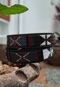 The Belts are made from ethically sourced leather in Kenya. The collars are then hand beaded by Maasai women artisans from my Village in Kajiado who have mastered the art. The hardware is made from 100% recycled brass. TO MEASURE CORRECTLY Our measurements are from the tip of the Buckle of the Collar to the second hole after the beaded section. General Belt SizeNumerical Belt SizeWaist Measurement (inches) XS 30 26.5-28 S 32 28.5-30 M 34 30.5-32 M 36 32.5-34 L 38 34.5-36 L 40 36.5-38 XL 42 38.5- Traditional Leather Belt Buckle, Adjustable, Adjustable Leather Belt Buckles In Traditional Style, Adjustable Brown Traditional Belt Buckles, Adjustable Traditional Leather Belt Buckles, Adjustable Leather Belt Buckles, Traditional Style, Traditional Black Adjustable Belts, Traditional Adjustable Leather Belt, Traditional Adjustable Brown Belt Buckles, Artisan Adjustable Fabric Belt