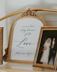 an ornate frame holds two framed photos and a wedding card