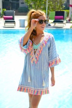 Rainbow Tassel Tunic :: NEW ARRIVALS :: The Blue Door Boutique Multicolor Fringe Beach Dress, Multicolor Fringe Dress For Beach, Cotton Fringe Dress For Vacation, Cotton Beach Dress With Tassel Ties, Beach Cotton Dress With Tassels, Summer Cotton Dress With Tassels, Multicolor Vacation Dress With Back Tassel Tie-up, Bohemian Striped Vacation Dresses, Bohemian Striped Dresses For Vacation