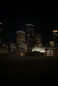 the city skyline is lit up at night