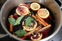 a pot filled with oranges and spices