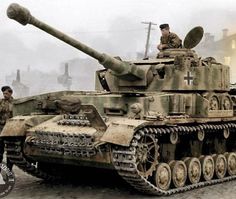 two men standing next to an old tank