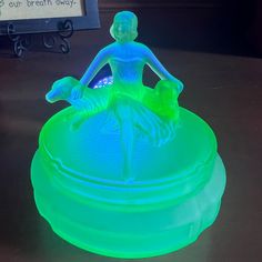 a green lit up statue sitting on top of a table