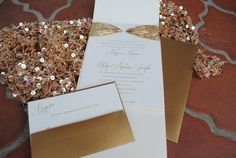 wedding stationery with gold sequins and ribbon