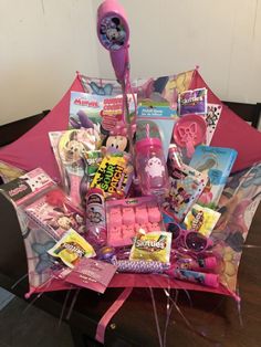 a pink umbrella with various items in it