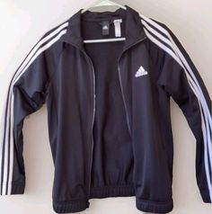 Elevate your activewear game with this stylish classic black and white  vintage Adidas track jacket. It is in excellent pre-owned condition with no stains snags for tears. One of the tags at the neck has some fraying. Featuring a full zip closure and elastic bottom, this mid-length jacket is perfect for all seasons and occasions, from travel to workwear. The jacket is made of lightweight knit fabric, making it wind-resistant and perfect for a variety of activities. The jacket also comes with features such as inner pockets, contrasting trim, and all-season suitability, making it a versatile addition to your wardrobe. Whether you're hitting the gym or going for a walk, this Adidas track jacket is the perfect choice for any athletic activity. Black And White Vintage, Adidas Vintage, Adidas Track Jacket, Style Sport, Adidas Track, Fabric Making, Vintage Adidas, Track Jacket, Lightweight Knit