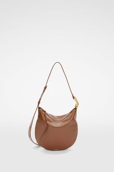 Moon Small Woman | Jil Sander Official Online Store Luxury Saddle Shoulder Bag With Adjustable Strap, Elegant Saddle Shaped Soft Leather Shoulder Bag, Elegant Soft Leather Saddle Shoulder Bag, Luxury Saddle Shoulder Bag With Palladium Hardware, Leather Saddle Shoulder Bag For Evening, Elegant Crossbody Hobo Bag With Brass Hardware, Designer Saddle Shoulder Bag For Formal Occasions, Evening Saddle Shoulder Bag With Gold-tone Hardware, Designer Formal Saddle Shoulder Bag