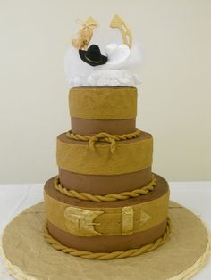 a three tiered cake with a bride and groom on top