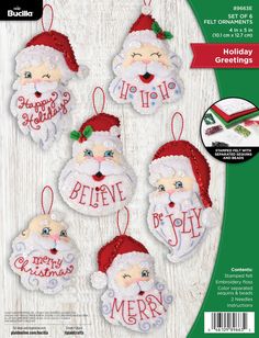 christmas ornament kits with santa's face and words on the front, in red