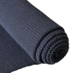 a black yoga mat rolled up on top of each other with one side folded down