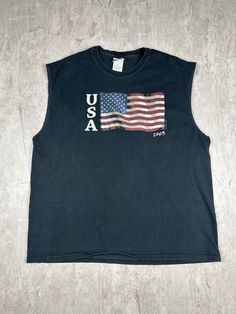 Show off your patriotic side with our 2003 American USA Flag Sonoma Jean Company Black Cut Off T-Shirt. This men's size XL tee features a bold American flag graphic and a stylish cut-off design, perfect for adding a touch of vintage Americana to your wardrobe. Please refer to the provided pictures for a detailed view of the condition and measurements of this item. We strive to present our pieces as accurately as possible, ensuring you have a clear understanding of their fit and wear. We put in our best efforts to clean and remove any stains, marks, etc. from our vintage pieces, but due to the nature of these items, some imperfections may remain. If you have any questions or require additional pictures, please don't hesitate to reach out to us! Black Flag Print Top For Streetwear, Black Crew Neck Top Made In Usa, Patriotic Black Top With Flag Print, Patriotic Black Tops For Labor Day, Black Pre-shrunk Tops For 4th Of July, Patriotic Black Top For Labor Day, Memorial Day American Flag Print Tops For Streetwear, Memorial Day American Flag Print Top For Streetwear, American Flag Print Tops For Memorial Day Streetwear