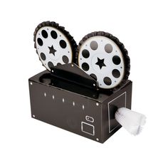 two black and white wheels with stars on them sitting in a box next to a brush