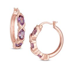 Express your modern style with these gorgeous gemstone hoop earrings. Crafted in sterling silver with 18K rose gold plate, each sophisticated hoop showcases three 6.0 x 4.0mm oval-shaped bright purple amethyst alternating with sculpted "X" shapes. Buffed to a brilliant luster, these earrings secure with latch backs. Elegant Gold Amethyst Hoop Earrings, Elegant Purple Hoop Earrings, Hallmarked Rose Gold Hoop Earrings, Elegant Gemstone Hoop Earrings, Elegant Small Hoop Purple Earrings, Elegant Purple Pierced Hoop Earrings, Elegant Purple Small Hoop Earrings, Fine Jewelry Small Hoop Gemstone Earrings, Elegant Small Hoop Gemstone Earrings