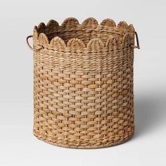 a large woven basket with handles on the bottom is shown in front of a white background