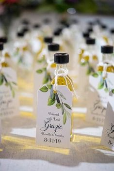 small bottles filled with olive oil sitting on top of a table