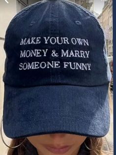 a woman wearing a blue hat that says make your own money and marry someone funny