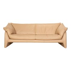 a beige leather couch with two pillows on it's back end and arms, viewed from the front