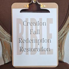 a clipboard with the words creation fall redemption restoration on it hanging from a chair