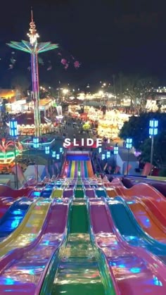 an amusement park at night with colorful rides