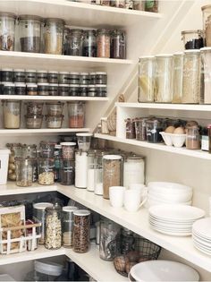 an organized pantry filled with lots of food and containers, including bowls, cups, and spoons