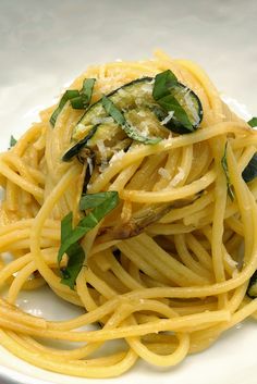 pasta with zucchini and spinach on a white plate