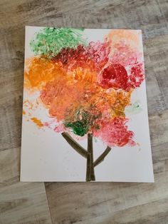 an art project made with colored paper and watercolors on a wooden table top