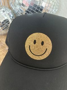 Product Description: Loving the trucker hat trend? We have you covered! Great for throwing on and heading out the door when you want to be trendy without a lot of effort. Gold Happy Face Quick Product Details and Features: Mesh back with adjustable snapback closure. Embroidered letters. Lightweight + Comfortable Product Fit: One size fits most. Product Care: Hand wash for spot care and let air dry. Shop Rooted and Free Notes: We offer free shipping on all orders $100 and over. We also offer free Embroidered Letters, Happy Face, Headband Hairstyles, Cardigan Jacket, The Door, Sales Gifts, Air Dry, Denim Dress, Trucker Hat