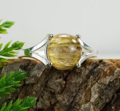 This is a beautiful and simple Rutile Quartz from Brazil set in Sterling SIlver. This amazing stone is colorless but has Golden Rutiles that occur naturally inside the gem. It is a rare occurrence that makes these gems very unique! This stone also has a special property that shows a cats eye effect when a bright direct light shines upon it! You will not see two Rutile Quartz that look exactly alike. This nicely sized 8mm round Rutile Quartz weighs 2.995cts and will go great with most styles or o Imperial Topaz, Rutile Quartz, Gemstone Stud Earrings, Cats Eye, Gemstone Studs, Gemstone Necklace Pendant, London Blue Topaz, Blue Topaz, Sterling Silver Ring