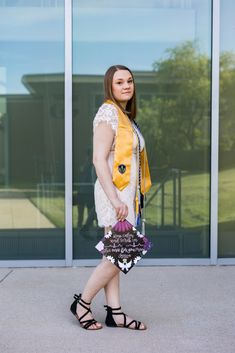 a woman in white dress and yellow scarf