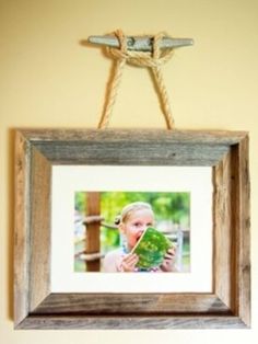 a wooden frame hanging on the wall with a photo in front of it and text below