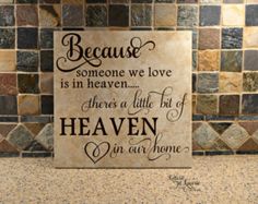 a sign that says because someone we love is in heaven there's a little bit of heaven in our home