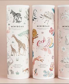 three different types of travel mugs with animals on them, one in pink and the other in white