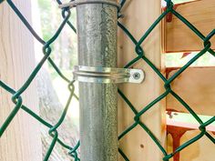 a close up of a metal pole on a chain link fence