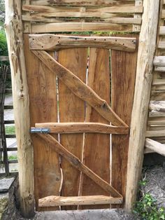 an old wooden door is open and ready to be used as a screen for the garden