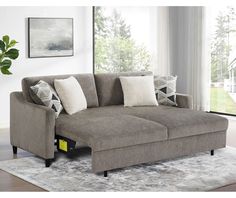 a living room scene with focus on the sectional sofa and throw pillows in the foreground