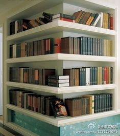 a bookshelf filled with lots of books next to a window