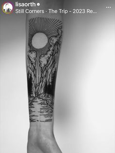 a black and white photo of a person's arm with a tattoo on it