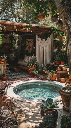 an outdoor hot tub surrounded by potted plants and hanging hammock decorations in the background