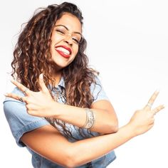 a woman with her arms crossed posing for the camera