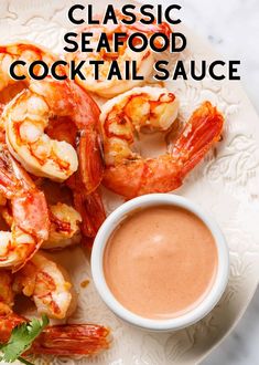 a white plate topped with shrimp and dipping sauce