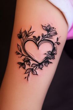 Floral heart tattoo on an arm with intricate black ink details. Cartoon Heart Tattoo, Creative Heart Tattoo, Heart On My Sleeve Tattoo, Cute Heart Tattoos, Heart With Flowers Tattoo, Unique Heart Tattoos, Heart Flower Tattoo, Heart Tattoo Ideas, Memorial Tattoo Quotes