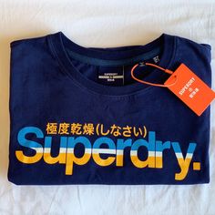 Superdry Vintage Tee, Designed To Fit Closer To The Body For A More Tailored Look With A Crew Neckline. Has A Cracked Effect Print And A Signature Logo Tab. Size: Us 10. Color: Navy *New With Tags (Comes From A Pet And Smoke Free Home). Sporty Blue Shirt With Text Print, Summer 2025, Superdry Mens, Vintage Tee, Signature Logo, Vintage Tees, Crew Neckline, Vintage Men, Tee Shirts