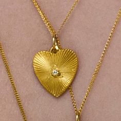 The 18K Yellow Gold Heart Medallion Necklace showcases a large flat heart with a .06ct diamond - a luxurious symbol of love and a dazzling addition to any ensemble. Details Gold Chain Large ILLUME Heart Medallion .06ct Diamond Metal Care Use the white side of the provided ILLUME Jewelry polishing cloth to gently wipe clean, then remove any remaining tarnish with mild diluted soap. Rinse with warm water and dry thoroughly before storing the piece in its jewelry pouch. Gemstone Care Use a soft cloth to gently wipe clean, then remove any remaining impurities with mild diluted soap. Rinse with warm water and dry thoroughly before storing in the provided jewelry pouch. Gold Necklace With Single Diamond Heart Pendant, Gold Heart Pendant Necklace With Single Diamond, Gold Necklaces With Single Diamond Heart Cut, Gold Necklace With Heart Cut Single Diamond, Heart Cut Gold Necklace With Single Diamond, Gold Diamond Heart Necklace Luxury Style, Gold Heart Cut Single Diamond Necklace, Luxury Heart Pendant Necklace With Diamond Accents, Luxury Heart Cut Necklace With Heart Charm