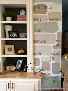 a white book shelf with some paint on it and shelves in the corner next to it